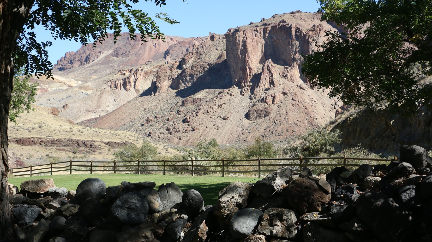 Red rock spires and a historic ranch in the Owyhee canyonlands of Oregon